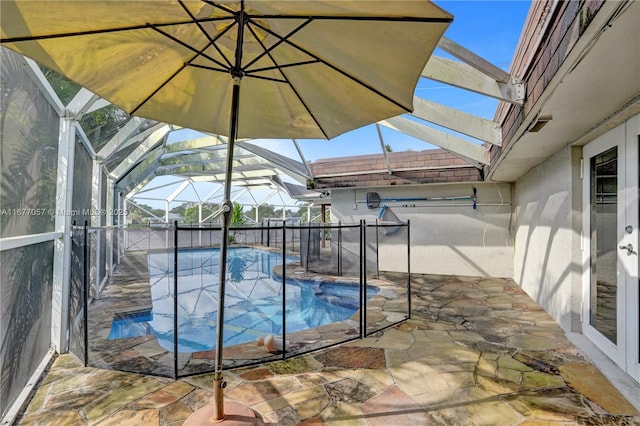 view of swimming pool with glass enclosure, a patio area, and a fenced in pool