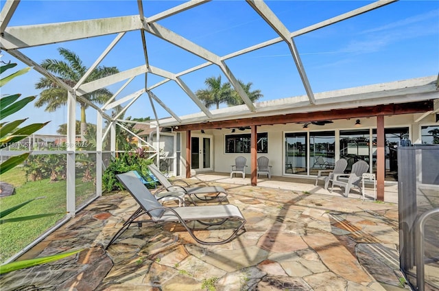 unfurnished sunroom featuring ceiling fan