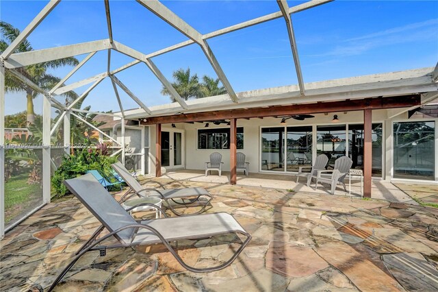 view of patio featuring an outdoor pool, glass enclosure, a water view, ceiling fan, and french doors