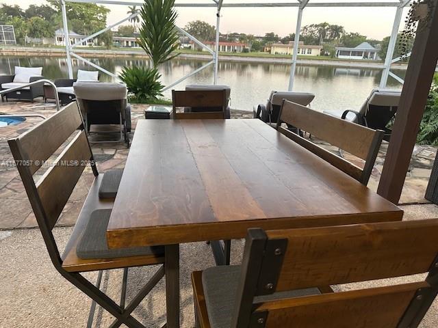 exterior space featuring outdoor dining space and a water view