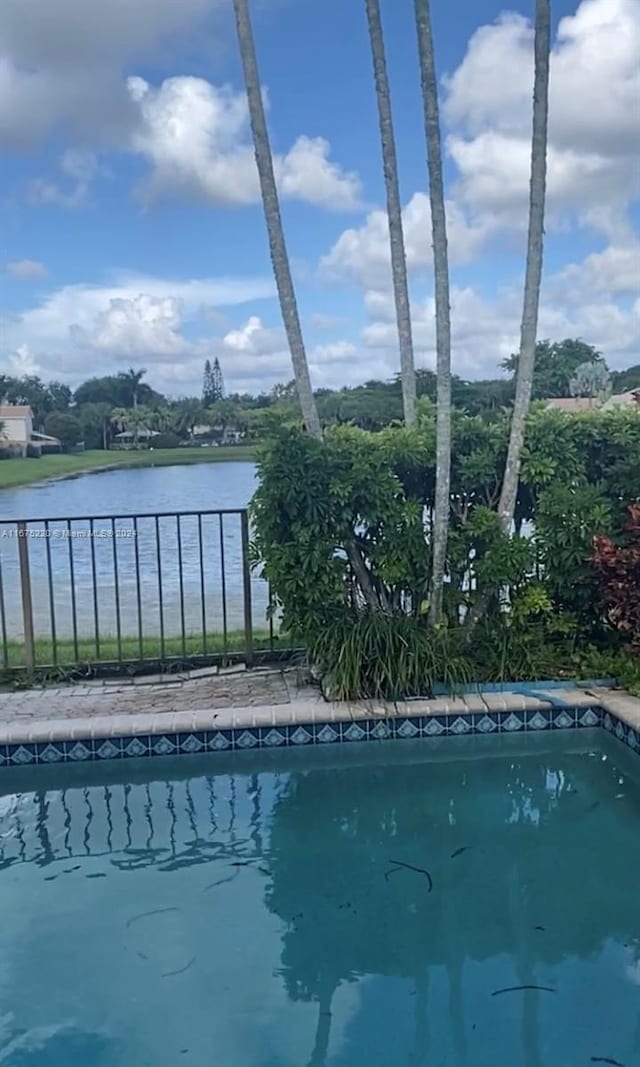 view of pool featuring a water view