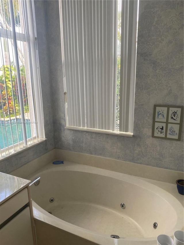 bathroom featuring vanity and a tub