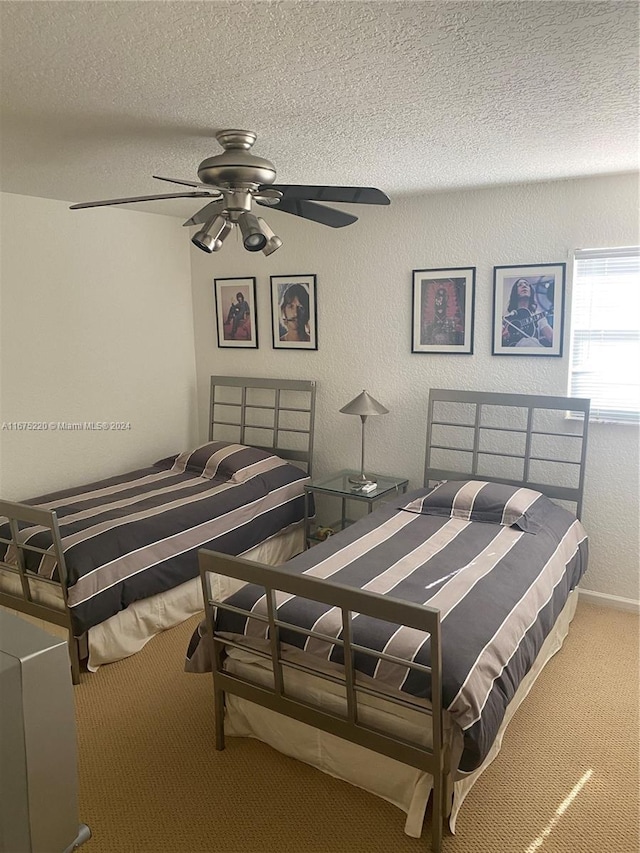 carpeted bedroom with a textured ceiling and ceiling fan