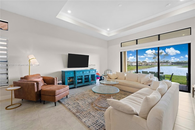 living room with crown molding, light tile patterned flooring, and a tray ceiling