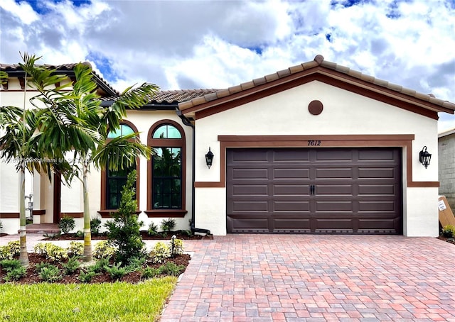 7612 Knight St, Parkland, FL 33067 - mediterranean / spanish house featuring decorative driveway, a tiled roof, an attached garage, and stucco siding