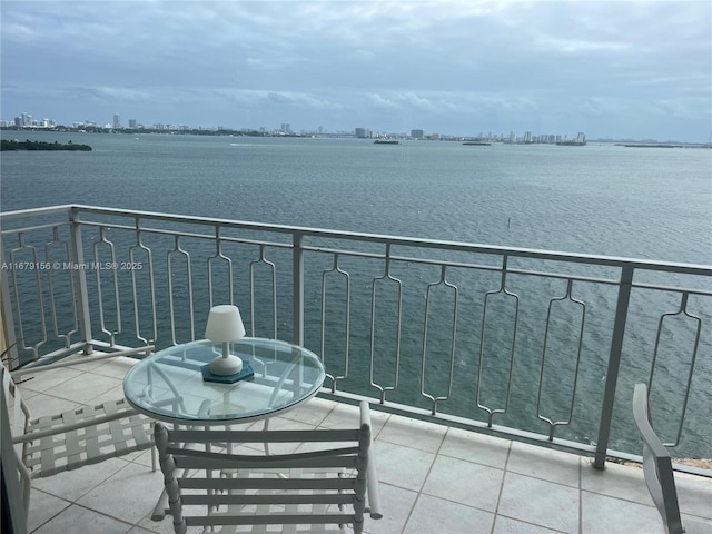 balcony with a water view and a city view