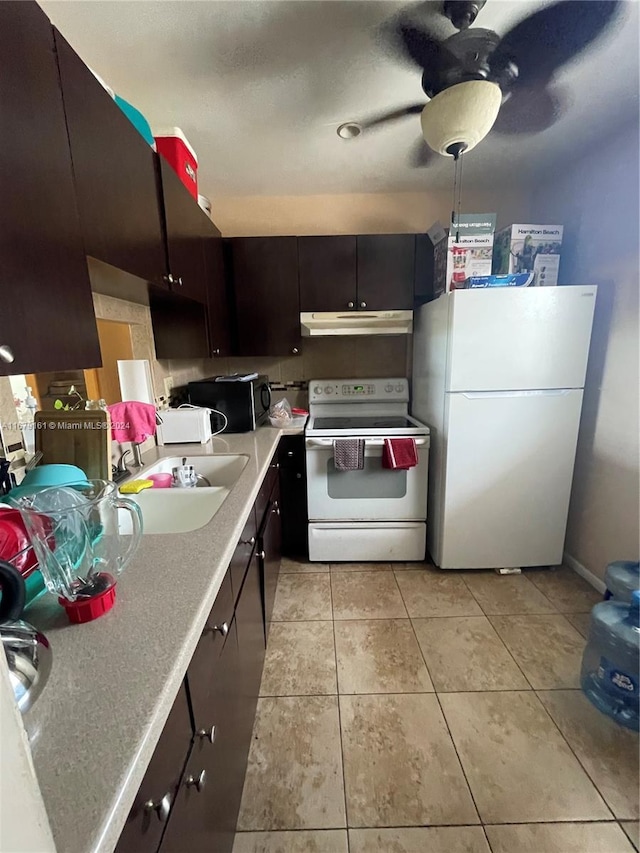 kitchen with dark brown cabinets, sink, light tile patterned flooring, white appliances, and ceiling fan