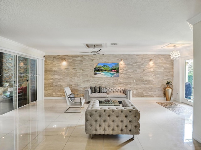 tiled living room with crown molding, a textured ceiling, and ceiling fan with notable chandelier