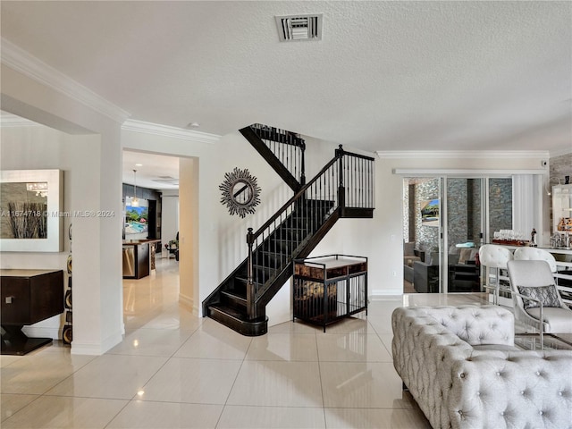 living room with ornamental molding, a textured ceiling, and tile patterned flooring