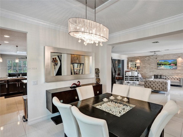 tiled dining space with sink, a notable chandelier, and crown molding