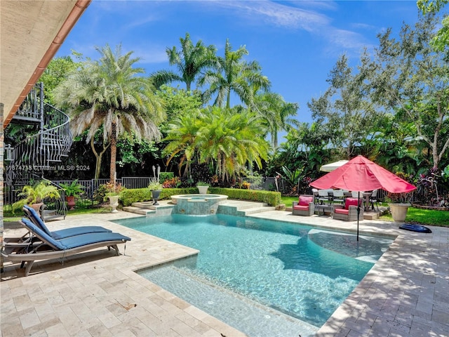 view of pool featuring an in ground hot tub and a patio area