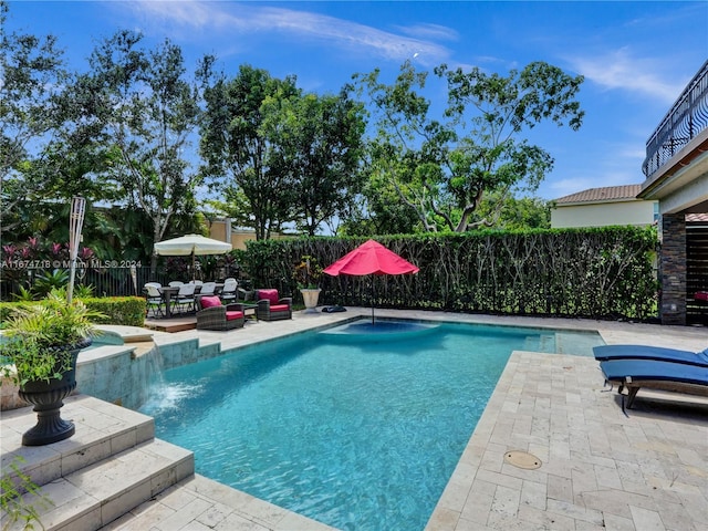 view of swimming pool featuring a patio and pool water feature