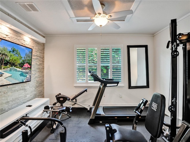 workout area with crown molding and ceiling fan