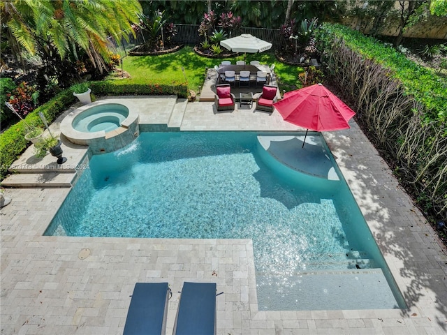 view of swimming pool featuring an in ground hot tub and a patio area