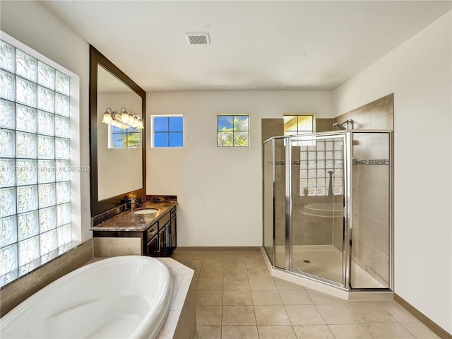 bathroom with vanity, shower with separate bathtub, and tile patterned flooring