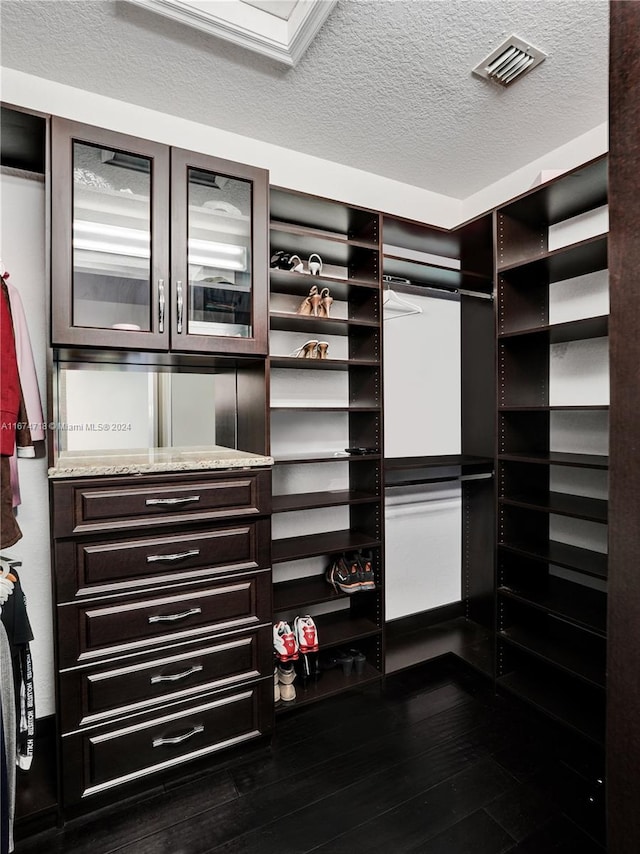 walk in closet featuring dark hardwood / wood-style floors