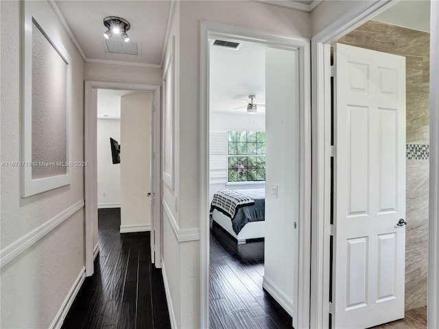 hallway with ornamental molding and dark hardwood / wood-style flooring