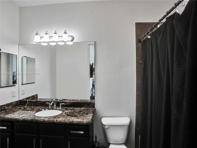 bathroom featuring vanity, toilet, and a shower with shower curtain