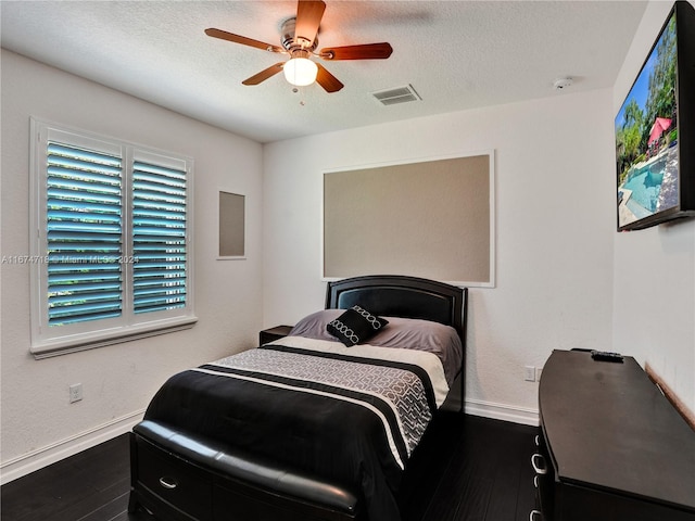 bedroom featuring ceiling fan, a textured ceiling, and hardwood / wood-style floors