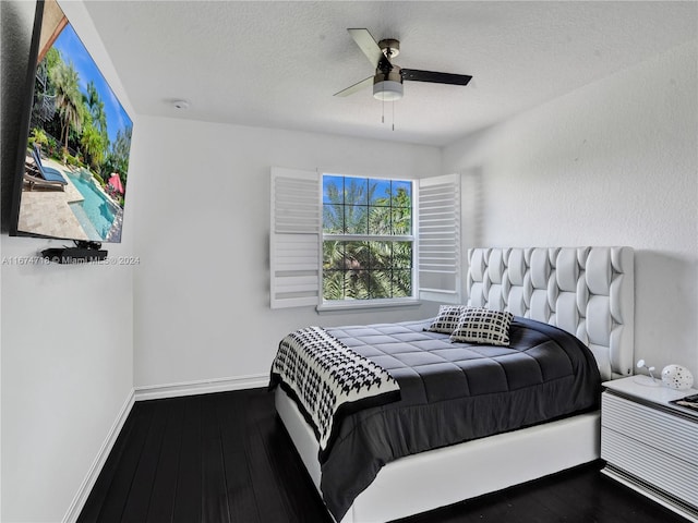 bedroom featuring hardwood / wood-style floors, a textured ceiling, and ceiling fan