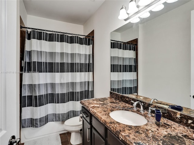 full bathroom featuring vanity, shower / bath combo with shower curtain, toilet, and tile patterned flooring