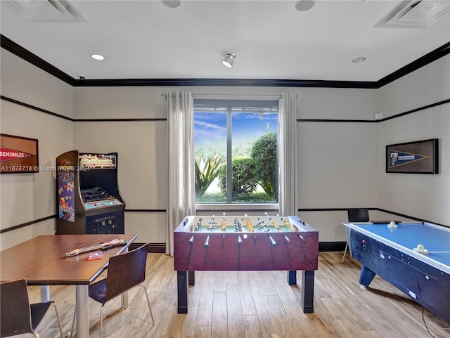 recreation room with light hardwood / wood-style flooring and crown molding