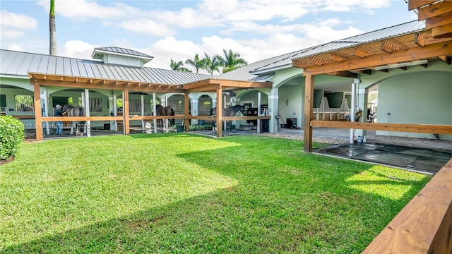 rear view of property featuring a yard