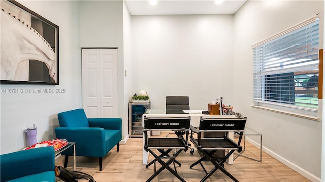 office featuring beverage cooler and light hardwood / wood-style floors