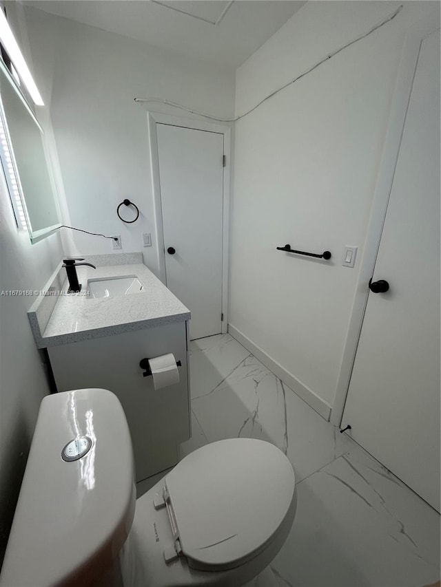 bathroom featuring vanity and toilet