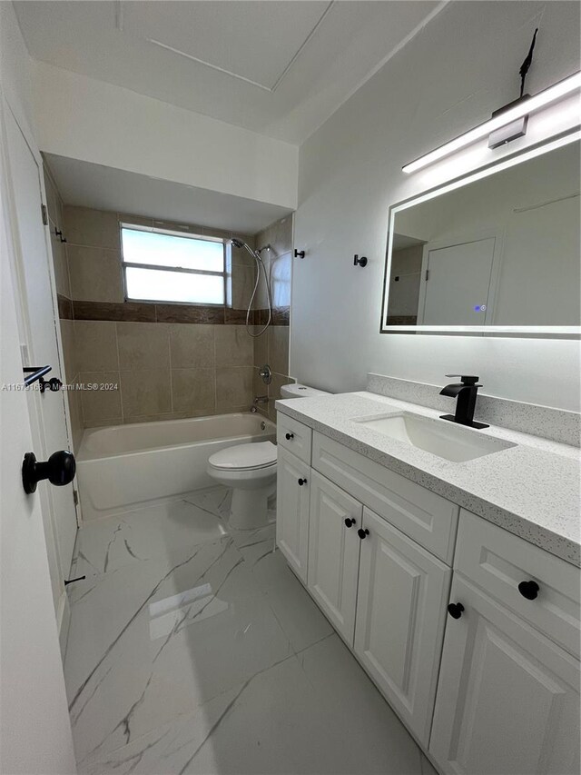 full bathroom featuring marble finish floor, vanity,  shower combination, and toilet