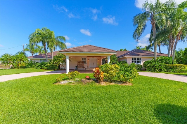 mediterranean / spanish house featuring a front lawn