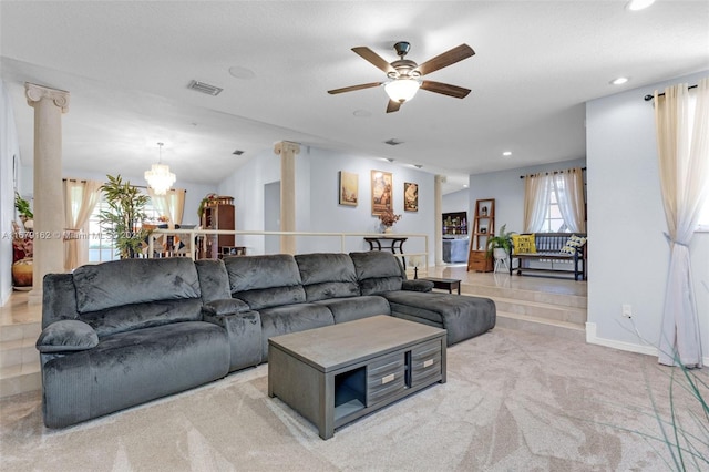 carpeted living room with lofted ceiling and ceiling fan with notable chandelier