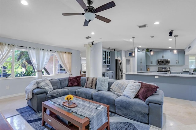 living room featuring light tile patterned floors and ceiling fan