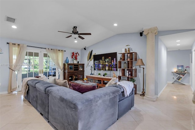 tiled living room with decorative columns, french doors, ceiling fan, and vaulted ceiling