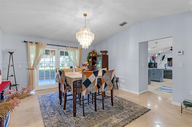 dining room with french doors, light tile patterned flooring, ceiling fan with notable chandelier, and vaulted ceiling