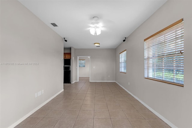 spare room with light tile patterned floors and ceiling fan