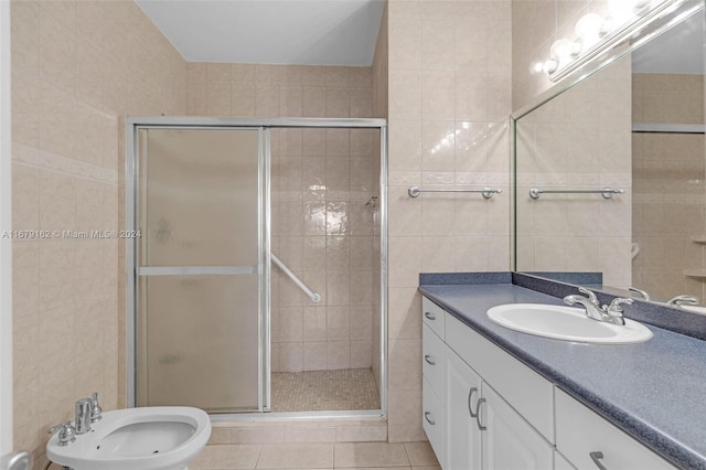 bathroom featuring tile walls, a shower with shower door, a bidet, vanity, and tile patterned floors