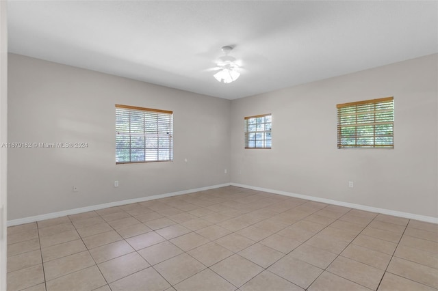 unfurnished room featuring ceiling fan and light tile patterned floors