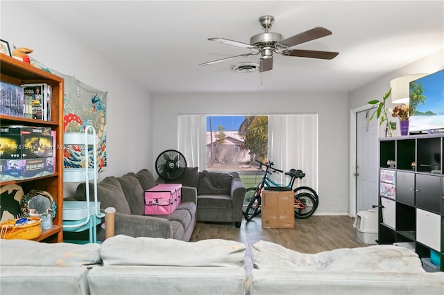 living room with ceiling fan and light wood-type flooring