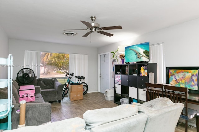 living room featuring ceiling fan and light hardwood / wood-style flooring