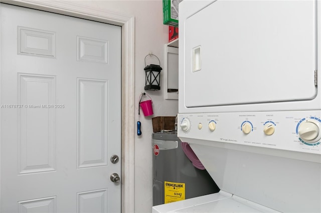 laundry area featuring stacked washer / drying machine and electric water heater