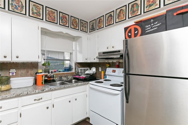 kitchen with white electric range oven, stainless steel fridge, sink, and white cabinetry