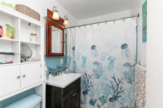 bathroom with vanity, backsplash, and curtained shower