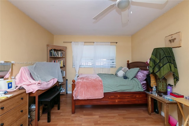 bedroom with ceiling fan and light hardwood / wood-style floors