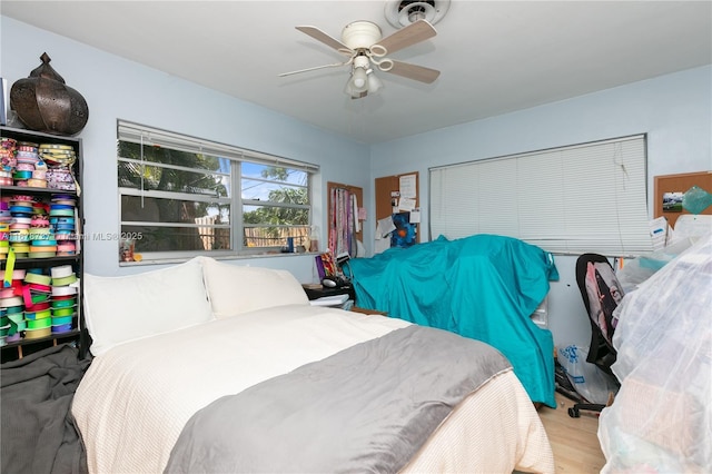 bedroom with ceiling fan and light wood-type flooring