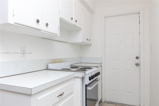 kitchen with white range with electric stovetop and white cabinetry