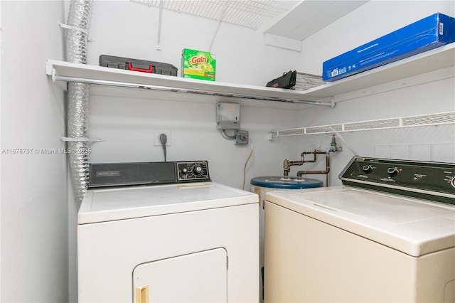 clothes washing area featuring washer and dryer