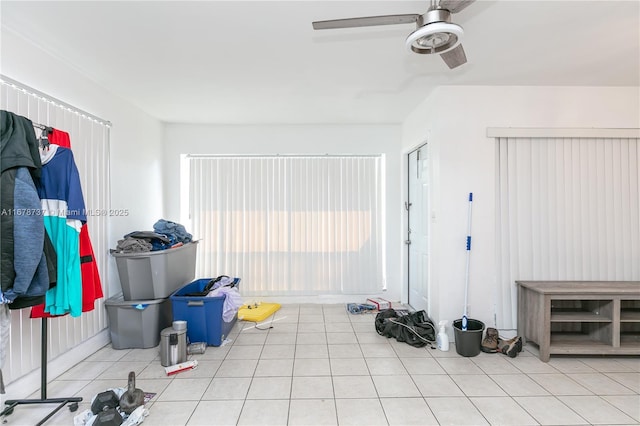 interior space with ceiling fan