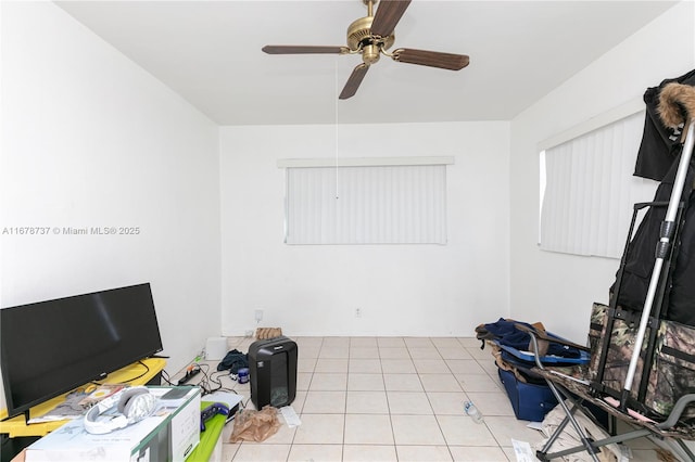 interior space with ceiling fan and light tile patterned flooring