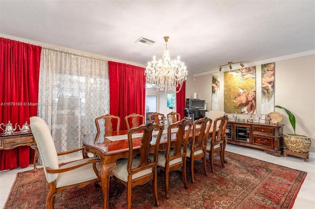 dining room featuring a notable chandelier and crown molding